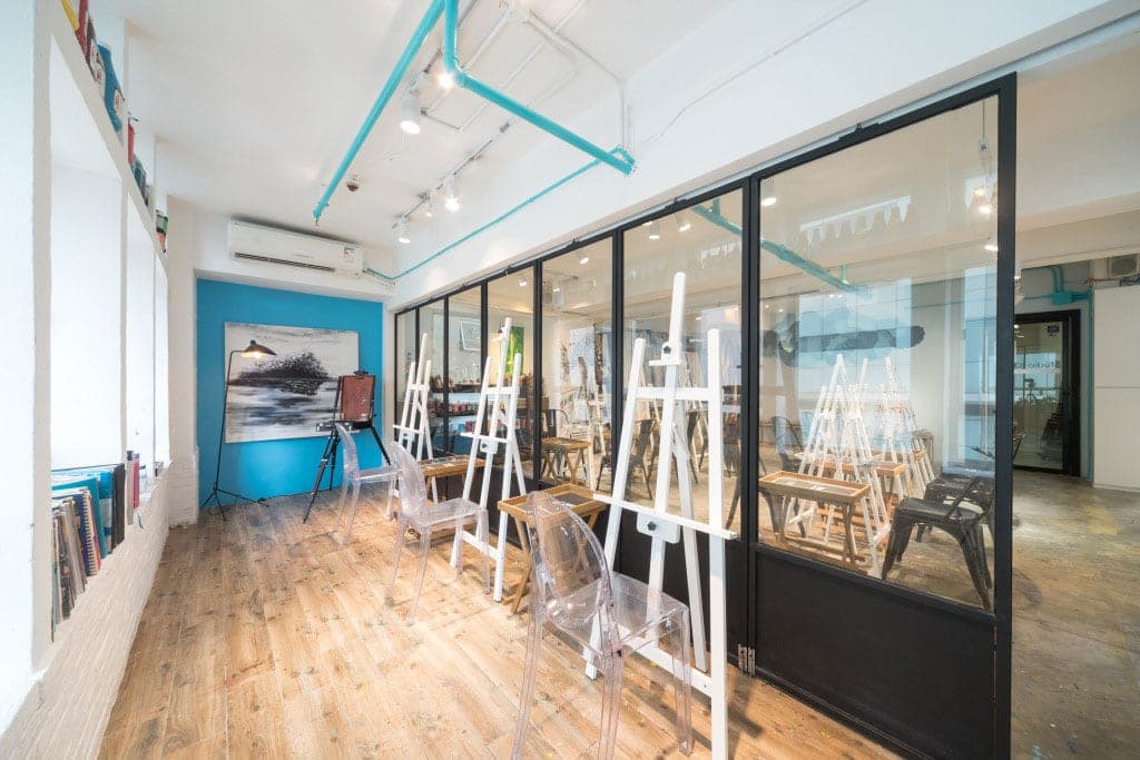 Rows of white easels at Studio 83 painting class studio in Central Hong Kong