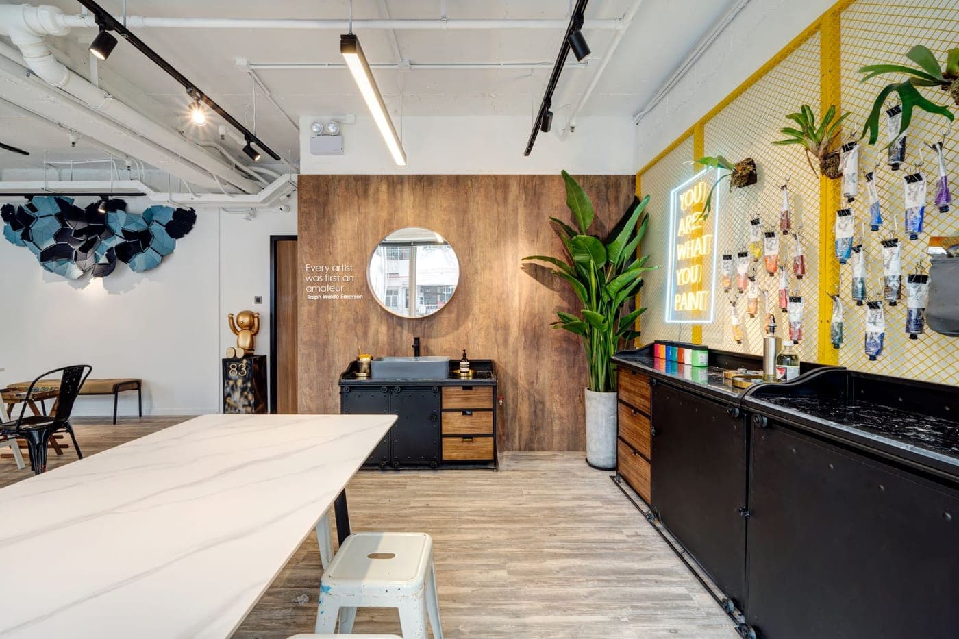 Studio 83 Hong Kong studio with YOU ARE WHAT YOU PAINT neon and painting supplies in Central